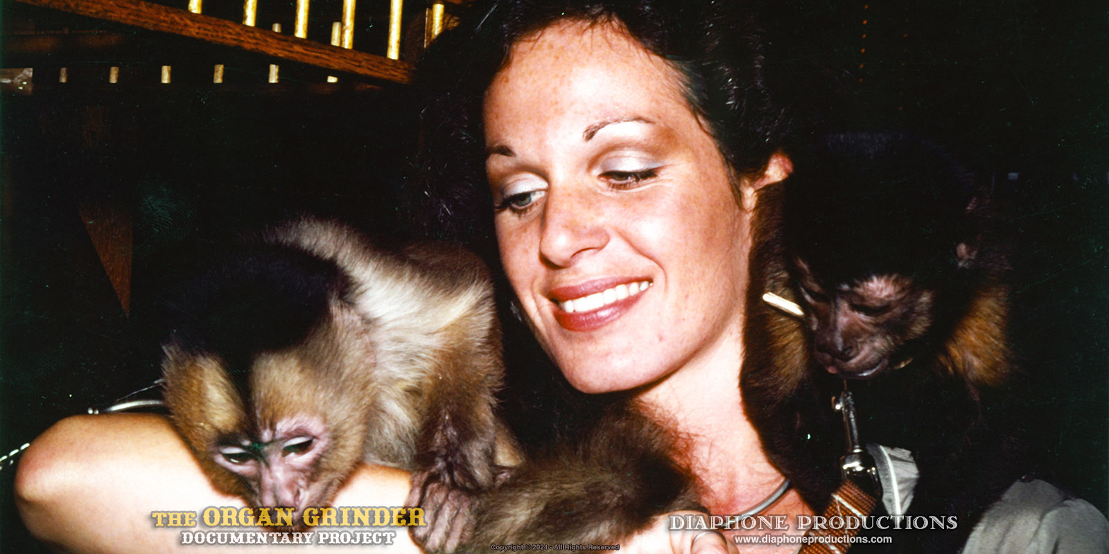 1970s photo of Vicki, the Organ Grinder's "Monkey Lady" with two small simian friends on her shoulders.